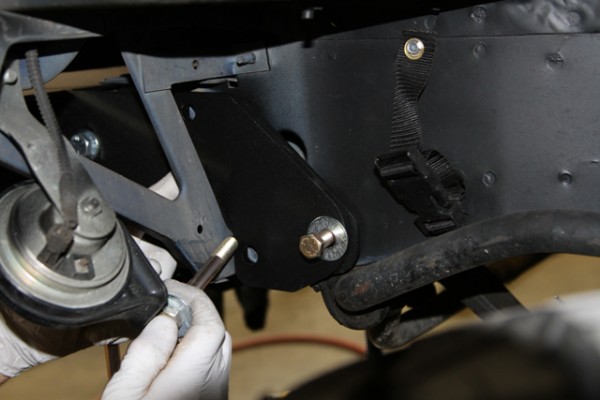 man threading bolt into off-road bumper mounting brackets