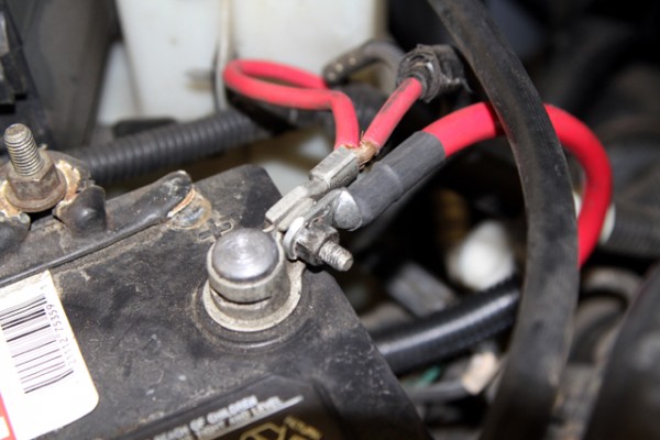 close up of batter terminal connections on a car