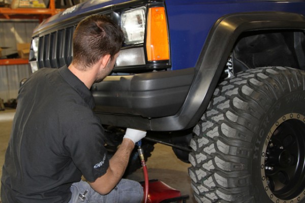 removing bolts from a factory Jeep XJ Cherokee front bumper