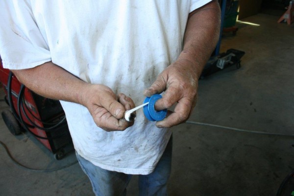 man wrapping teflon tape around compressed air hose fittings