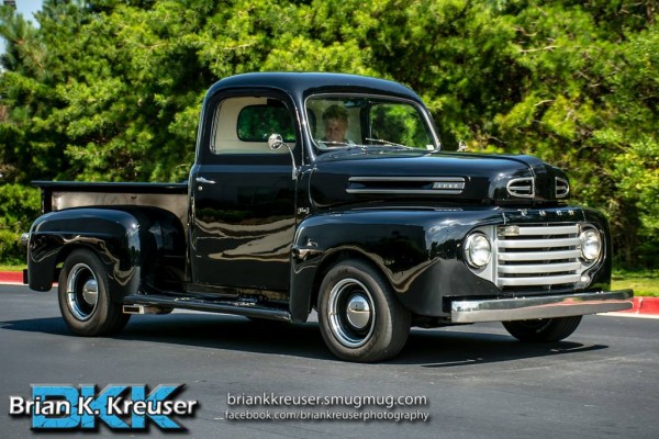 vintage ford pickup truck at a car show