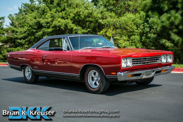 1969 red Plymouth gtx at a car show