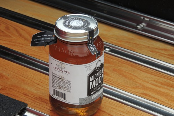 jar of moonshine on a vintage pickup truck bed