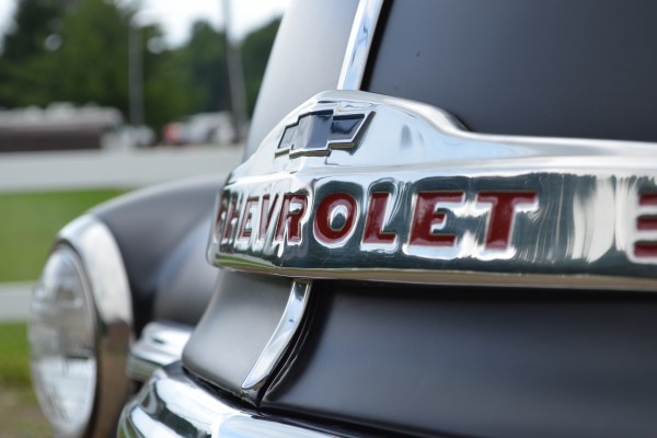 close up of Chevrolet bowtie badge on the grille of a 1949 chevy 3100 truck