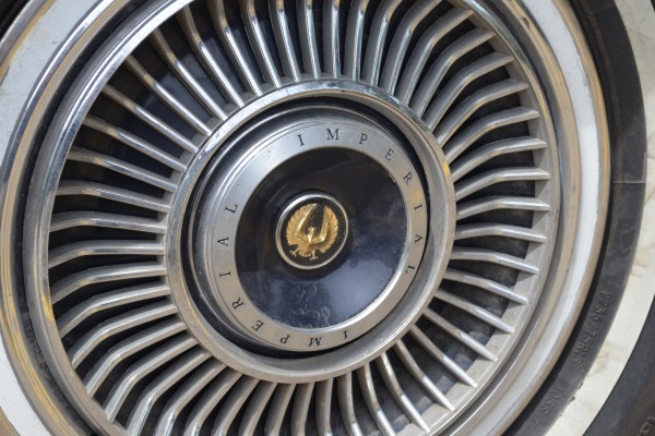 close up of the hubcap on a 1967 Chrysler Imperial
