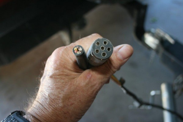 man holing a trailer light connection socket