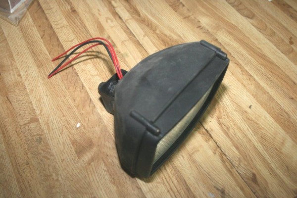 a truck fog light resting on a workbench
