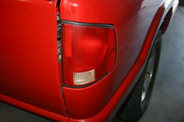 close up of the corner of an old pickup truck bed with taillight