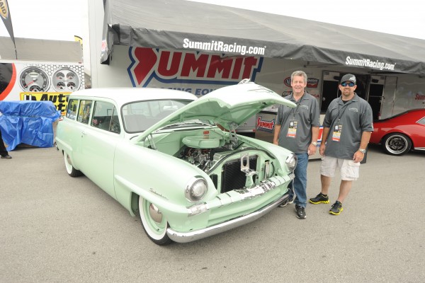 men pose with a custom 1953 Plymouth Suburban Wagon