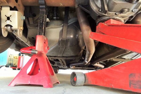 a ford mustang getting jacked up on jackstands for a repair