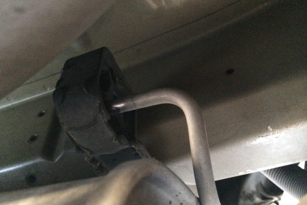 a muffler mount hooked into a rubber exhaust system isolator