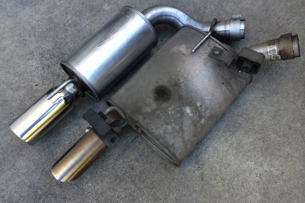 side by side comparison of a stock and a racing muffler
