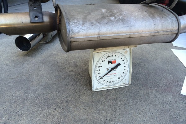 a stock muffler on a weight scale