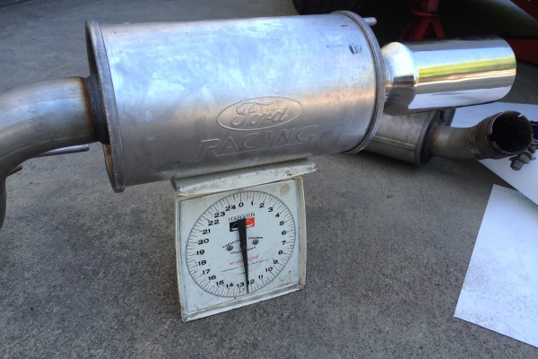 a racing muffler on a weigh scale