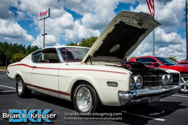 white ford torino fastback coupe at a car show