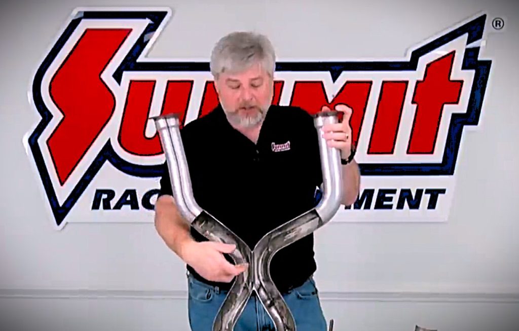 man holding an exhaust pipe for a car