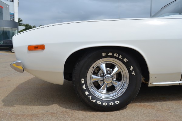 close up of a custom wheel on a white 1973 plymouth cuda