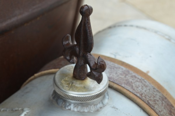 a wrought iron fixture on a rat rod gas cap