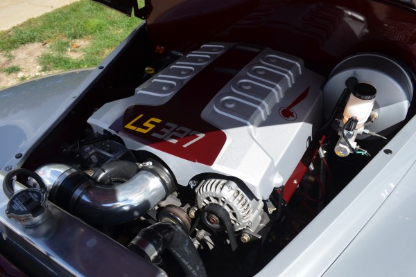 LS 327 engine under the hood of an old Pontiac car