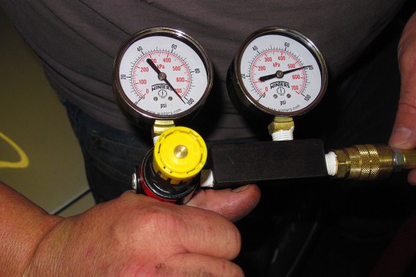 man using a leakdown tester