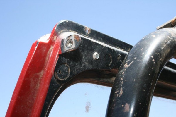 soft top mount on the windshield of an old jeep cj