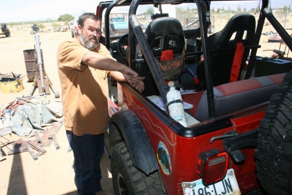 man installing jeep cj soft top tub rail