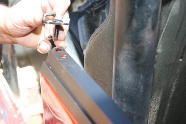 man installing jeep cj soft top tub rail