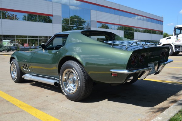 rear side view of a modified green 1969 chevy corvette stingray