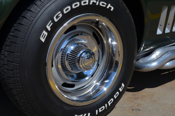 close up of a ralley wheel on a green 1969 chevy corvette stingray
