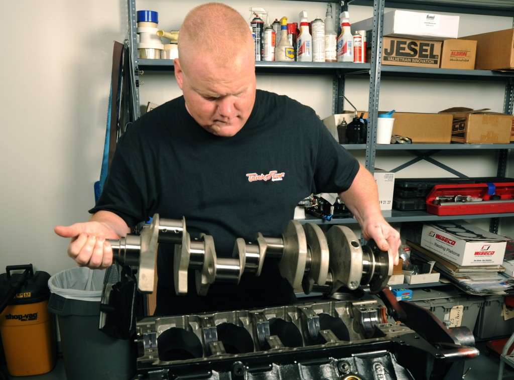man installing crankshaft on a big block chevy v8 engine