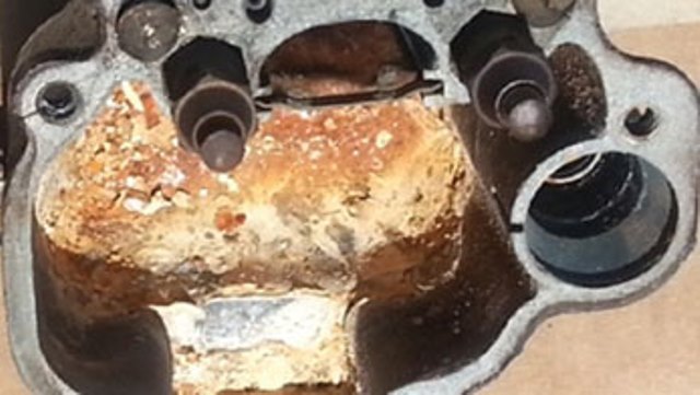 close up a corroded carburetor fuel bowl caused by ethanol
