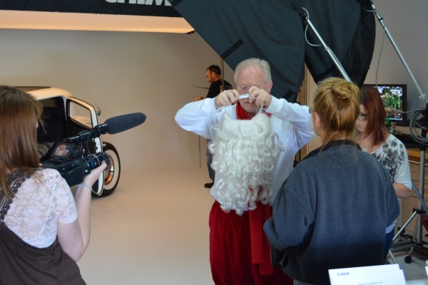 man dressing up as santa for photo shoot