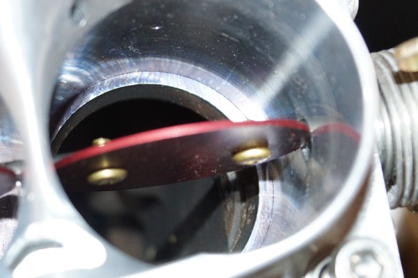 throttle blade inside a throttle body port mouth