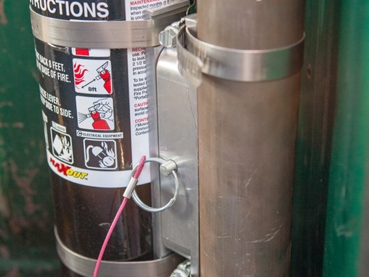 fire extinguisher mounted on a vehicle roll bar