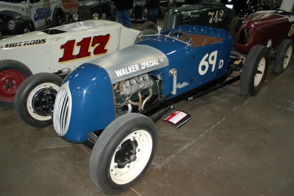 flathead ford powered midget racer on display in indoor car show