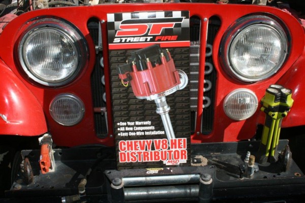 msd street fire distributor resting on a jeep cj bumper
