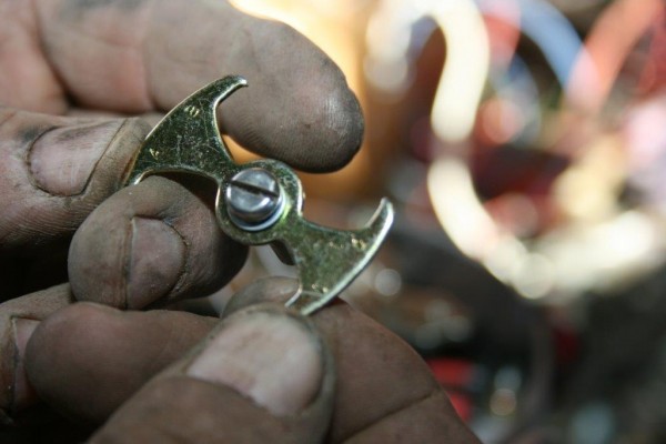 man holding a vacuum advance spring actuator