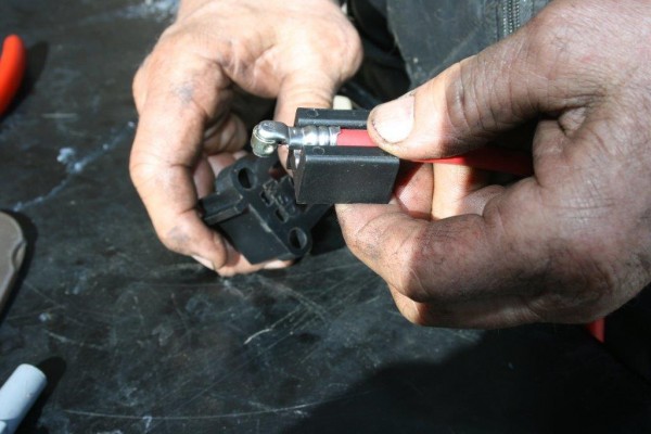spark plug wire placed in crimping die