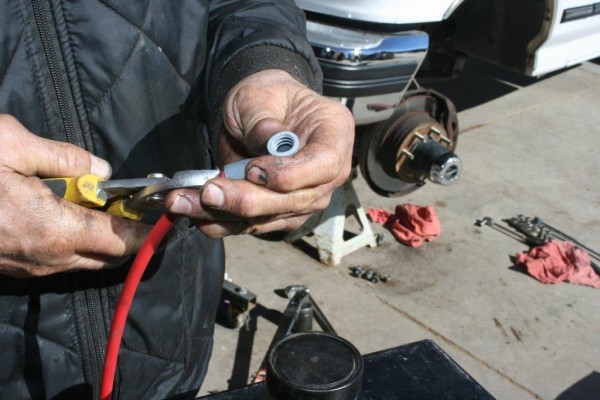 man crimping spark plug wires