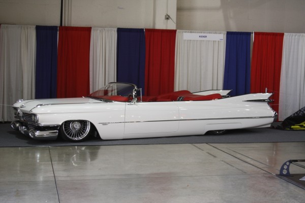 white lowered 1960s era cadillac convertible