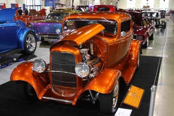 vintage orange hemi powered ford hotrod on display at car show