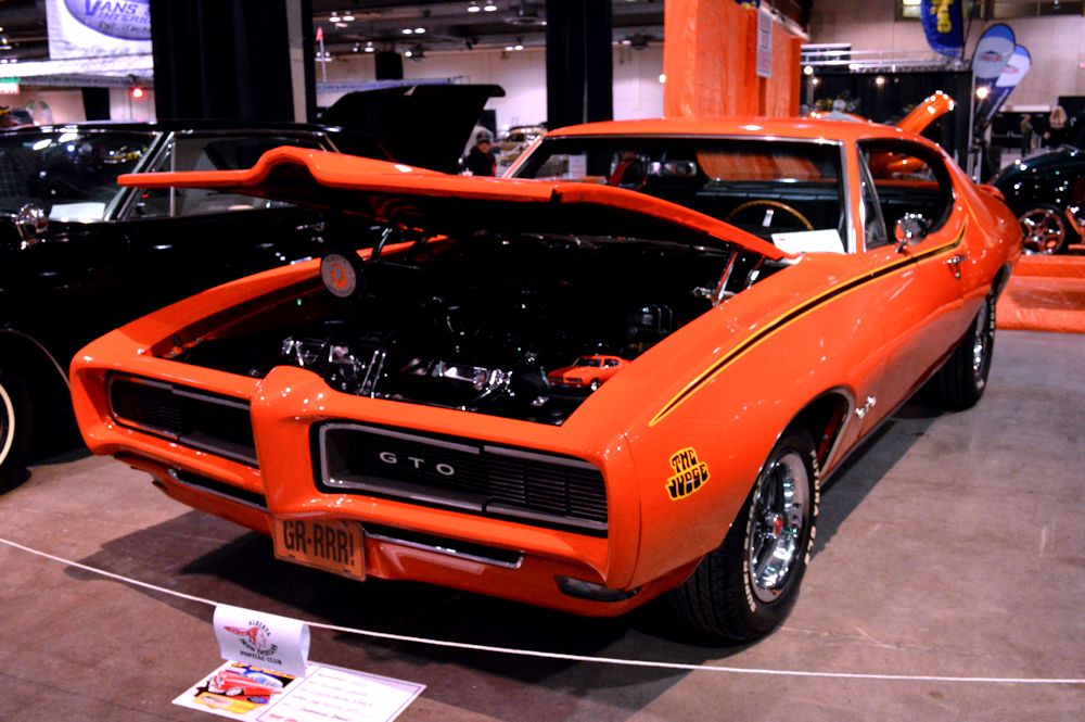 Orange pontiac GTO Judge at indoor car show