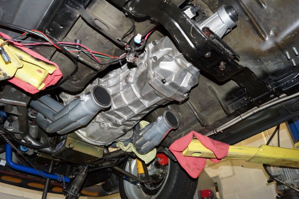 view from below of a foxbody mustang on a lift