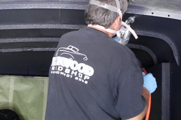 applying lizardskin spray coating to inside of a vintage delivery truck