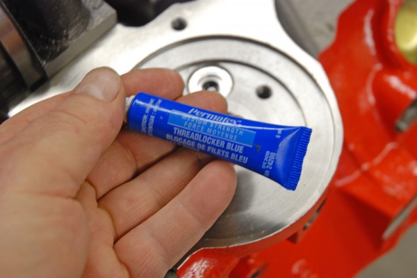 man holding blue permatex threadlocker