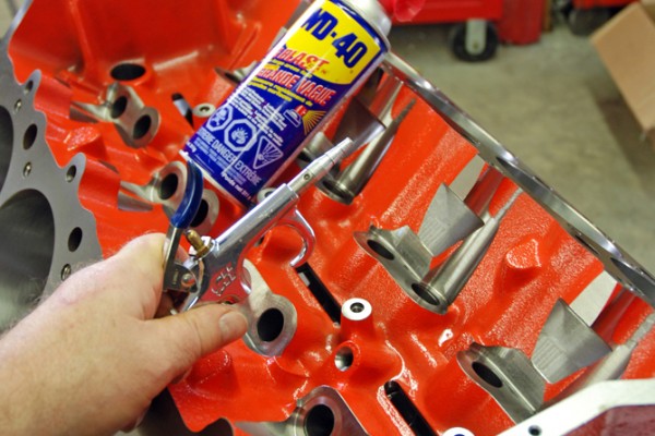 using an air gun to blow debris from an engine block