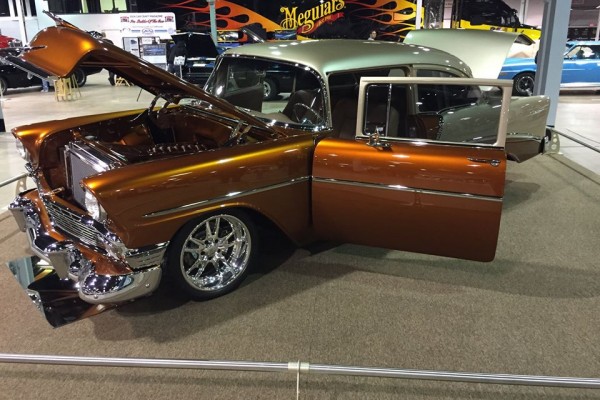 1956 chevy custom 2 door post coupe displayed at a car show