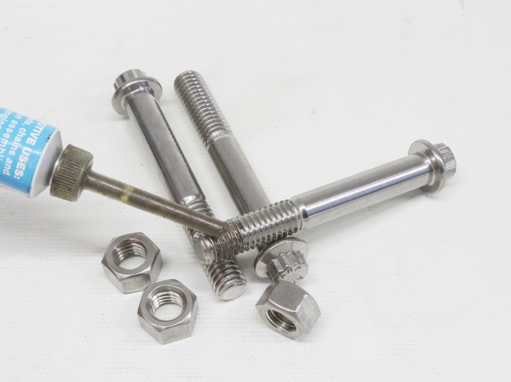 applying thread lubricant anti seize to an engine bolt