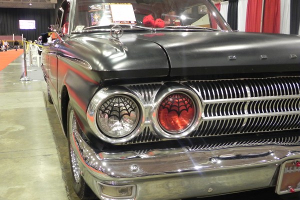 close up of spider web stickers on the headlights of an old car