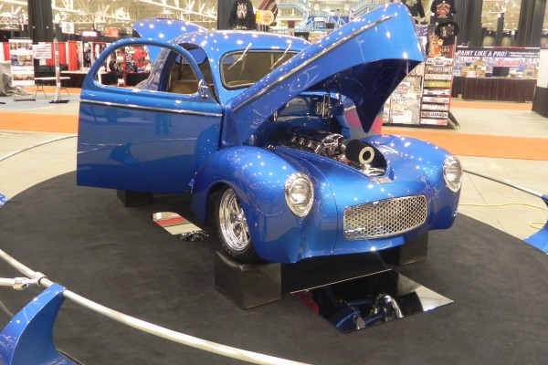 willys hot rod coupe on display at indoor car show